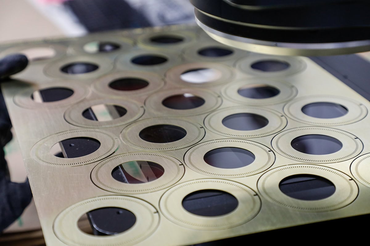 metal sheet being inspected under microscope
