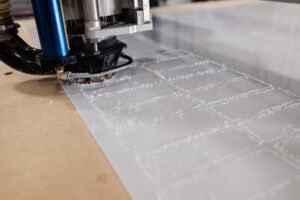 CNC router cutting white tiles
