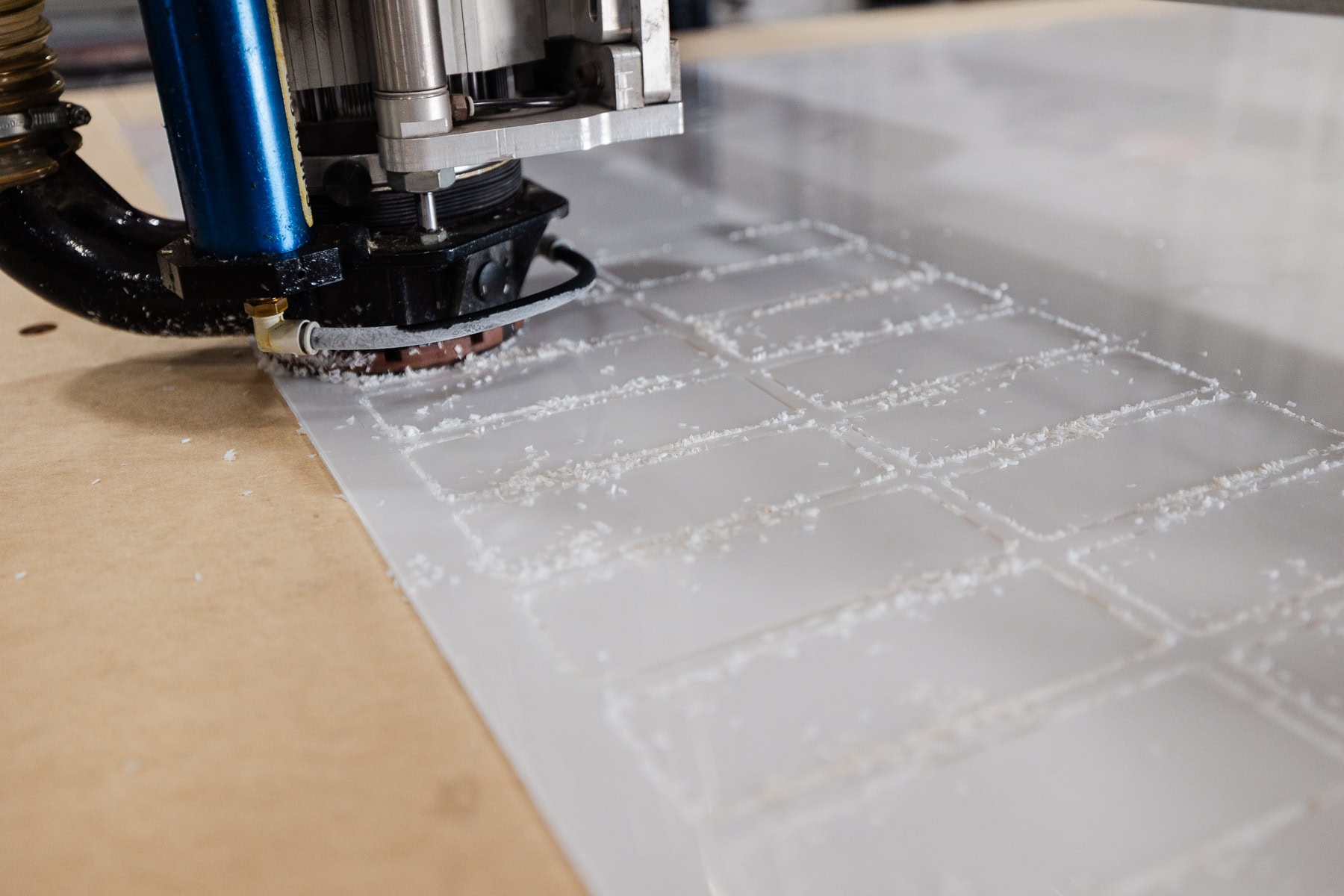 CNC router cutting white tiles