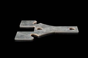 Flat, silver metal key-like tool with three prongs and two circular holes on a black background.