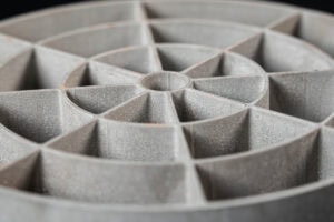 Close-up of a circular, segmented mold with triangular pockets radiating from the center.