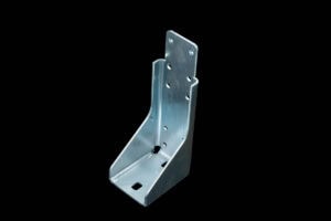 Metal mounting bracket with multiple holes for screws, shown against a black background.