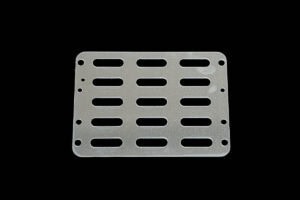 Silver perforated metal plate with rows of elongated oval holes on a black background, likely a vent or mounting plate.