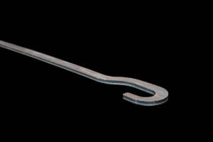 Metal crowbar with a curved claw on one end against a black background on a diagonal axis.