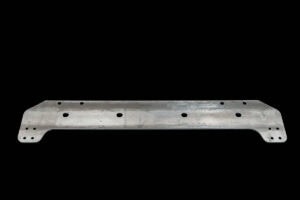 Long metal mounting bracket with multiple holes and rounded ends, laid on a black background (machinery/vehicle component).