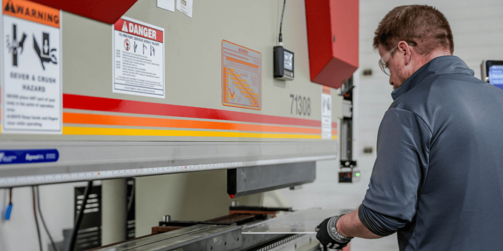 machine operator working with material on press machine