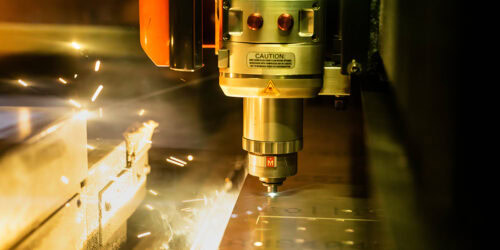 mazak laser cutter | MET Manufacturing Group, LLC close up of mazak laser cutter in action. sparks flying in background